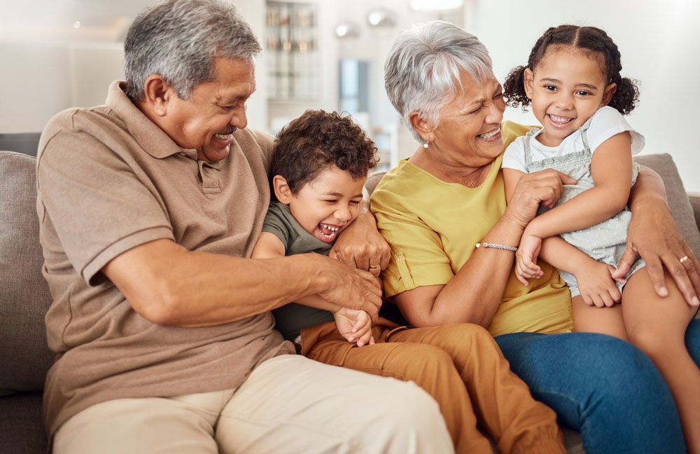 Happy grandparents and grandchildren smiling during family dental care for Dentures