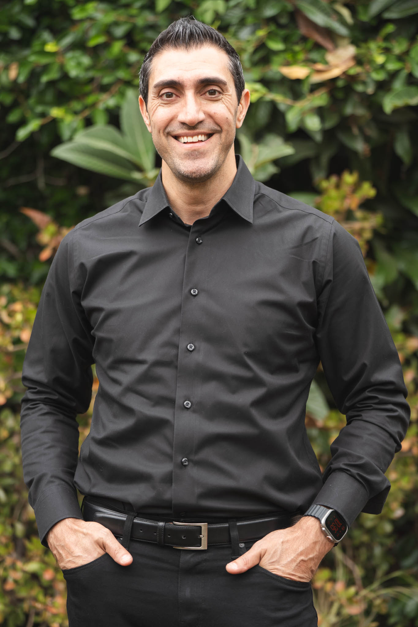 Smiling A Briter Smile team member in a black button-up shirt